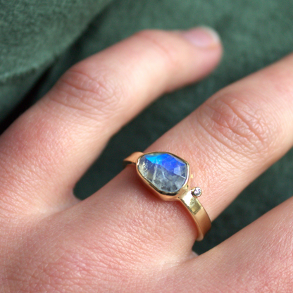 Unieke 14 karaat geelgouden ring met een fantasie geslepen regenboog maansteen en een fijne witte diamant handgemaakt door Goudsmederij Goedbloed